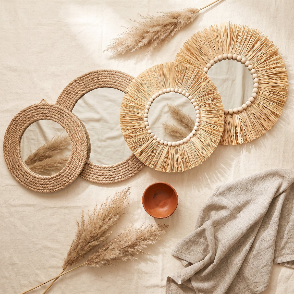 Raffia and rope wall mirror collection, overhead flat lay of all four mirrors